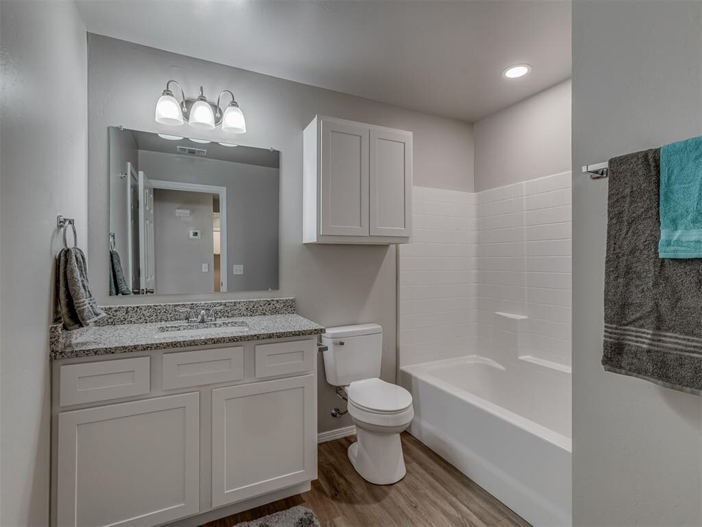 Finished bathroom remodel with dark vanity and bathtub