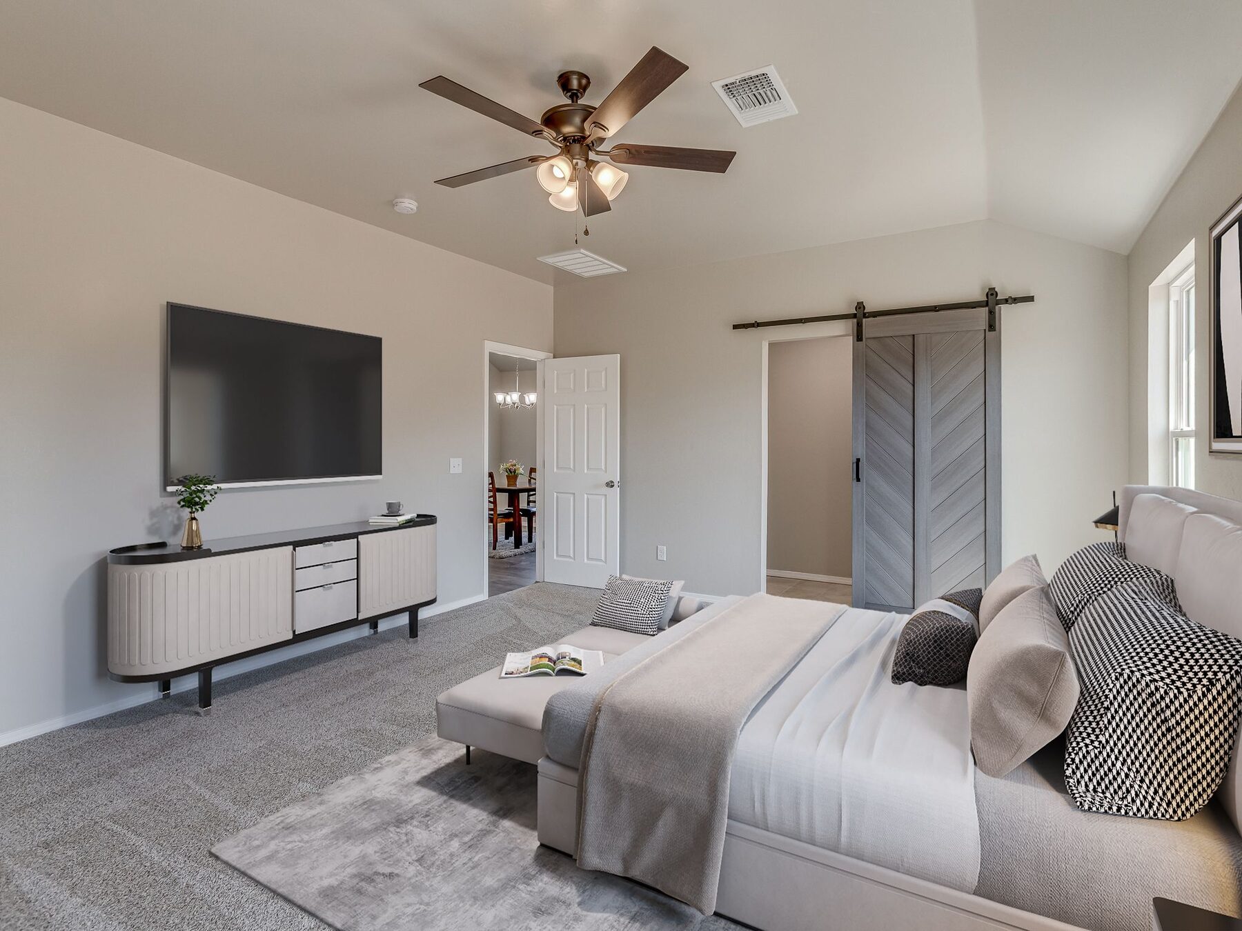 Finished bedroom with vaulted ceiling and sliding barn door in Norman, Oklahoma