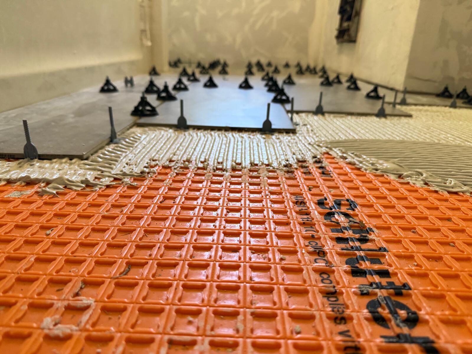 Schluter waterproofing membrane and tile installation in progress in Norman, Oklahoma