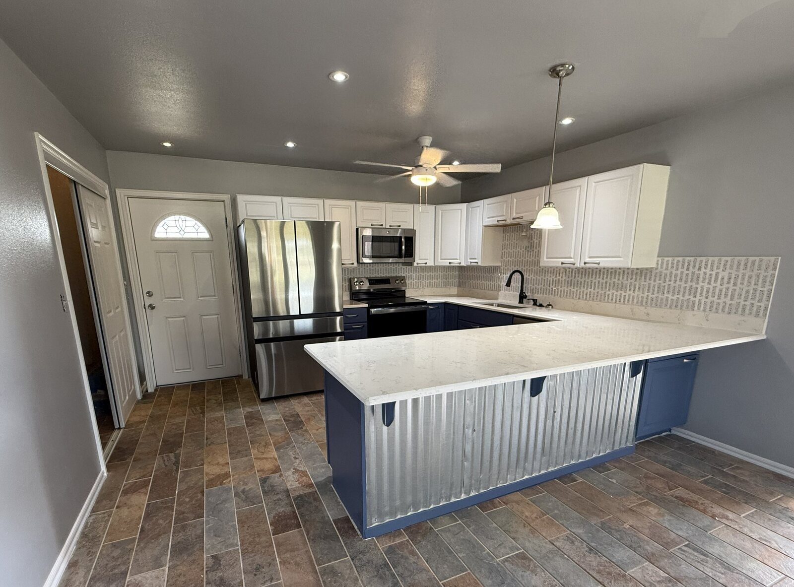 Remodeled kitchen with blue and white cabinetry
