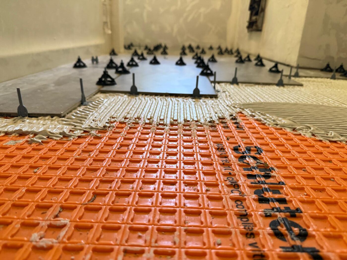 Schluter waterproofing membrane and large-format tile installation in progress